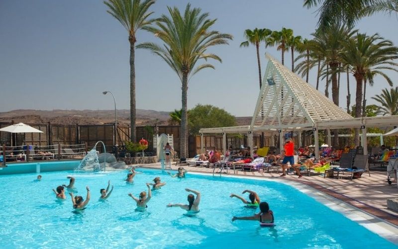 outdoor swimming pool with hotel guests doing aquarobics at the Abora Continental Hotel, Gran Canaria.
