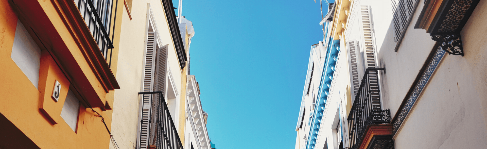 Tall buildings in Seville against a clear blue sky