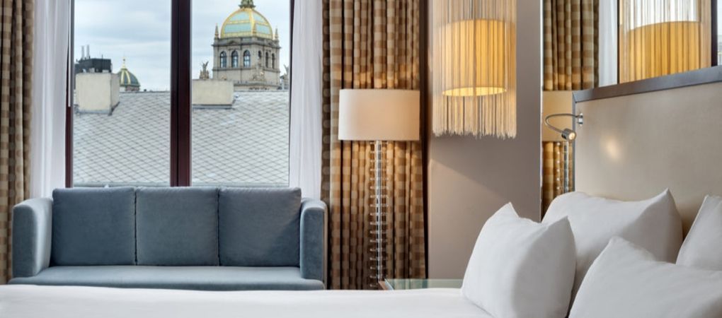 double bed with a sofa and a city view