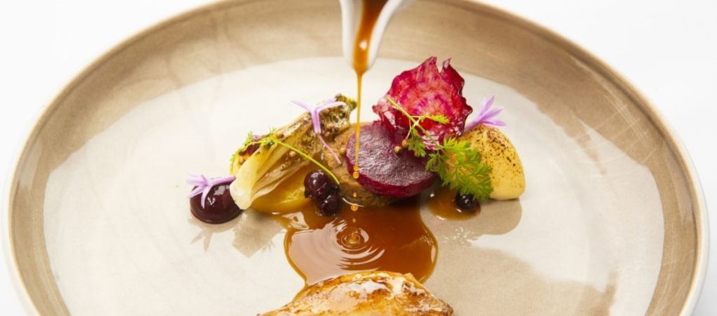 chicken and salad with sauce drizzling on top