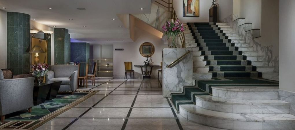 reception hallway leading to stairs, with lifts available elsewhere