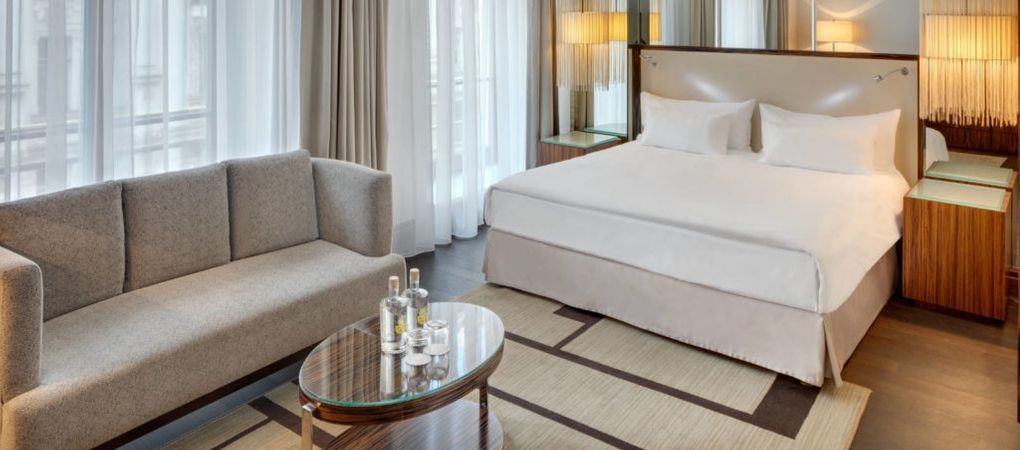 spacious double bedroom with a double bed and sofa