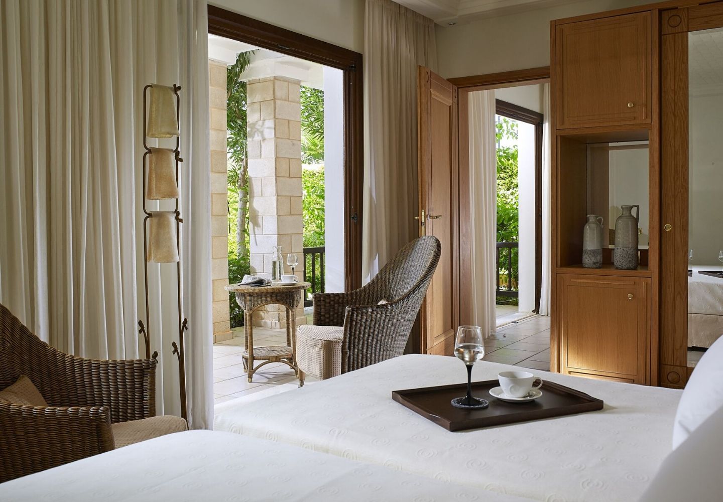 bright and spacious hotel room with a garden view