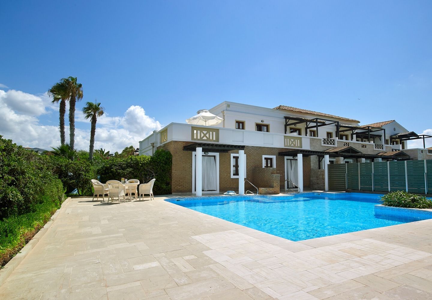 villa exterior equipped with an outdoor swimming pool
