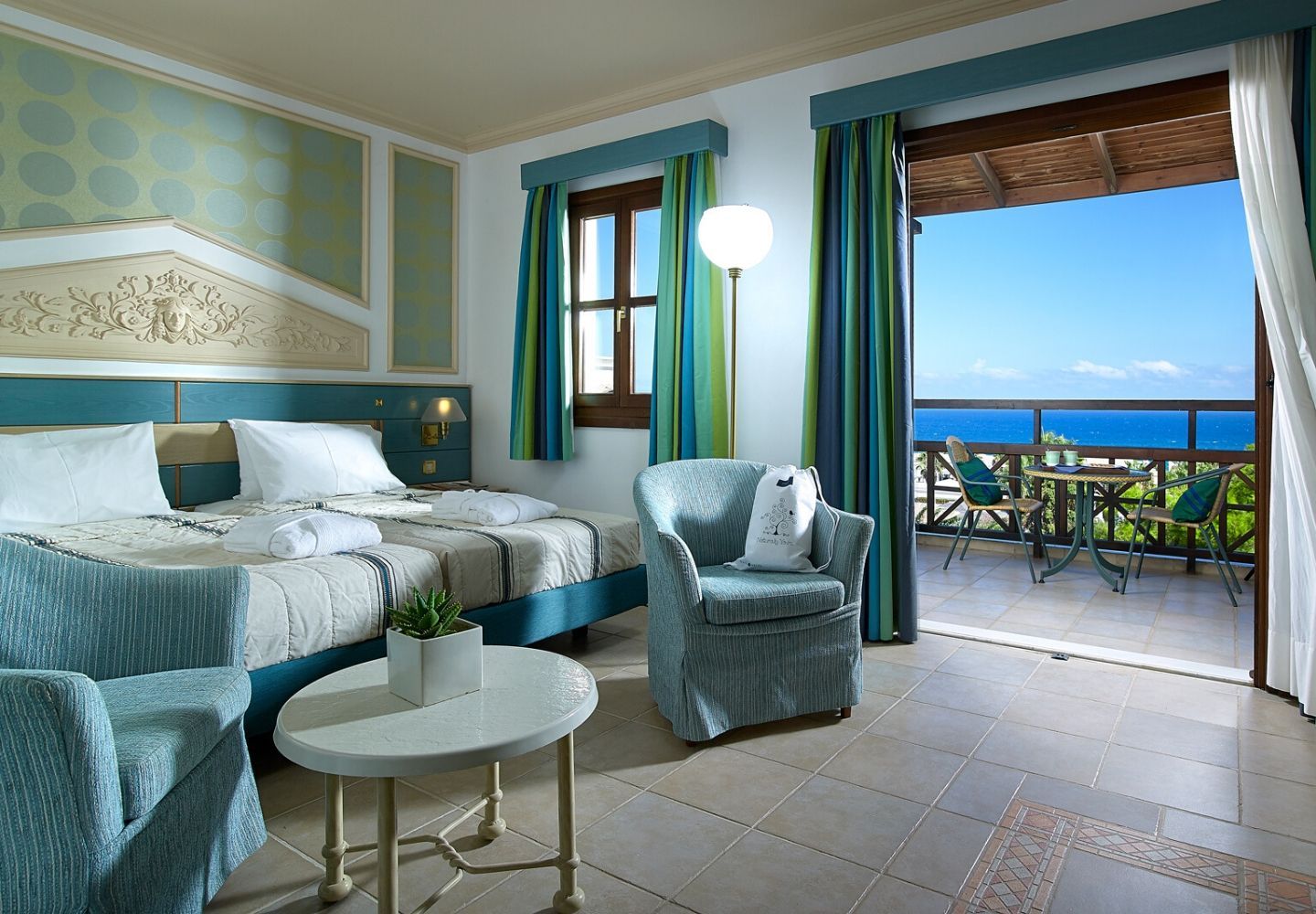 bright and spacious hotel room with a sea view
