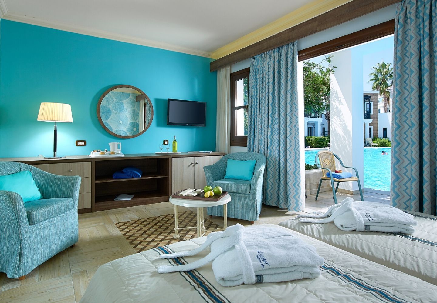 bright and spacious hotel room with a pool view