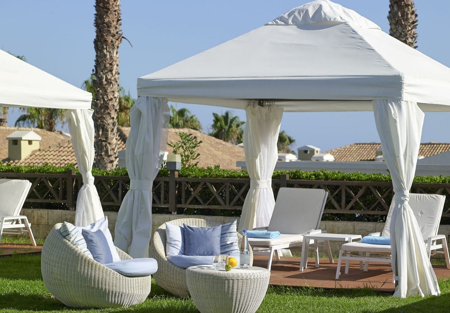 luxury sunbeds covered by canopys