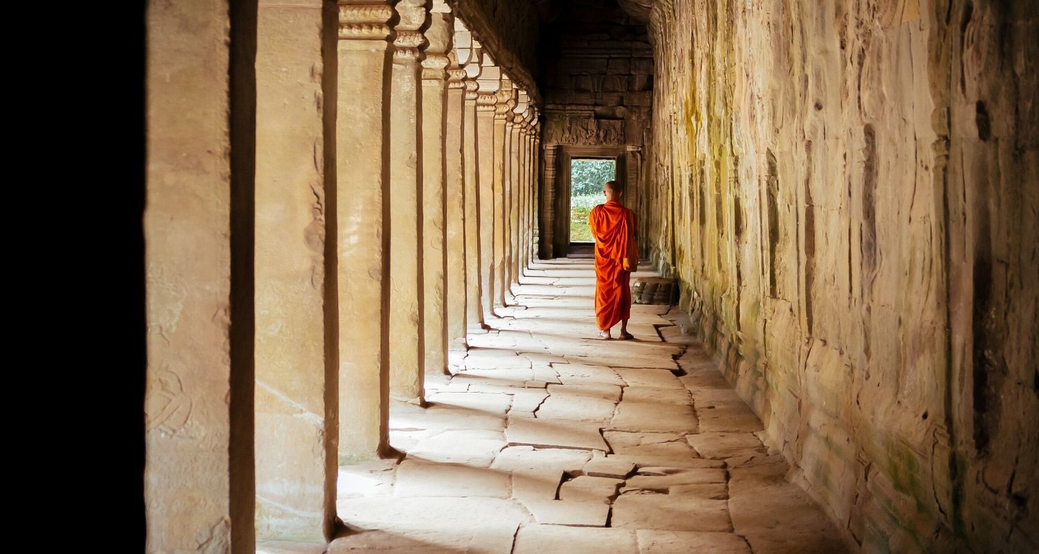 corridor with a Buddhist monk standing at the bottom