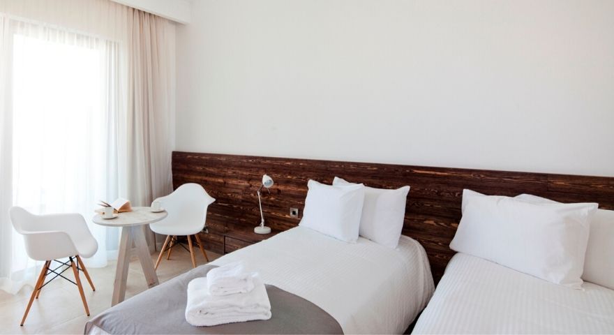 bright twin room with a small desk near the bed