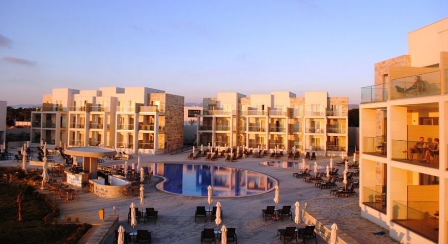 sun setting on the hotel and outdoor swimming pool