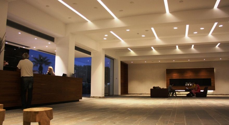 lobby and reception desk at night, warmly lit by overhead lighting