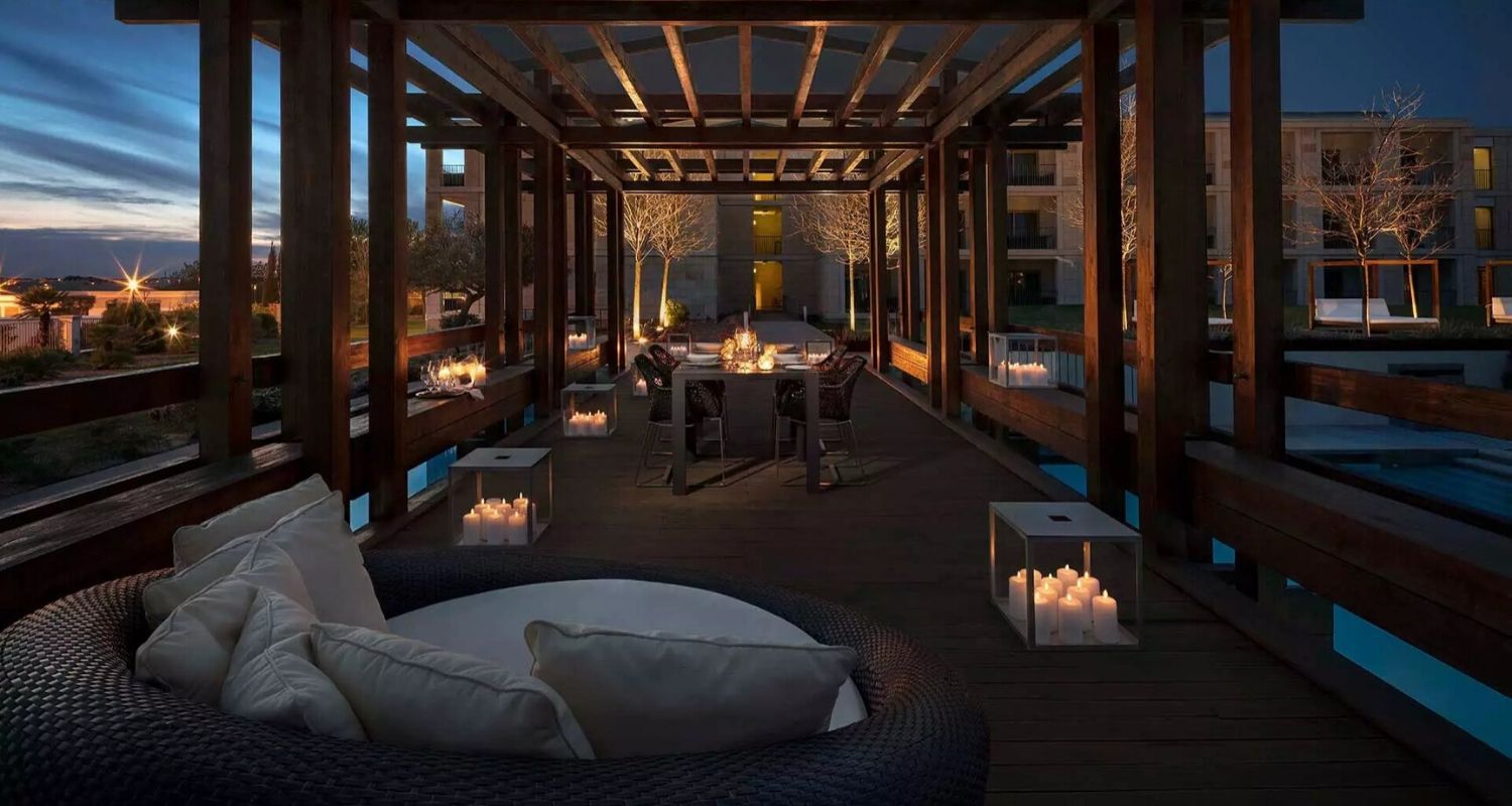 Outdoor dining area at night, offering a romantic setting