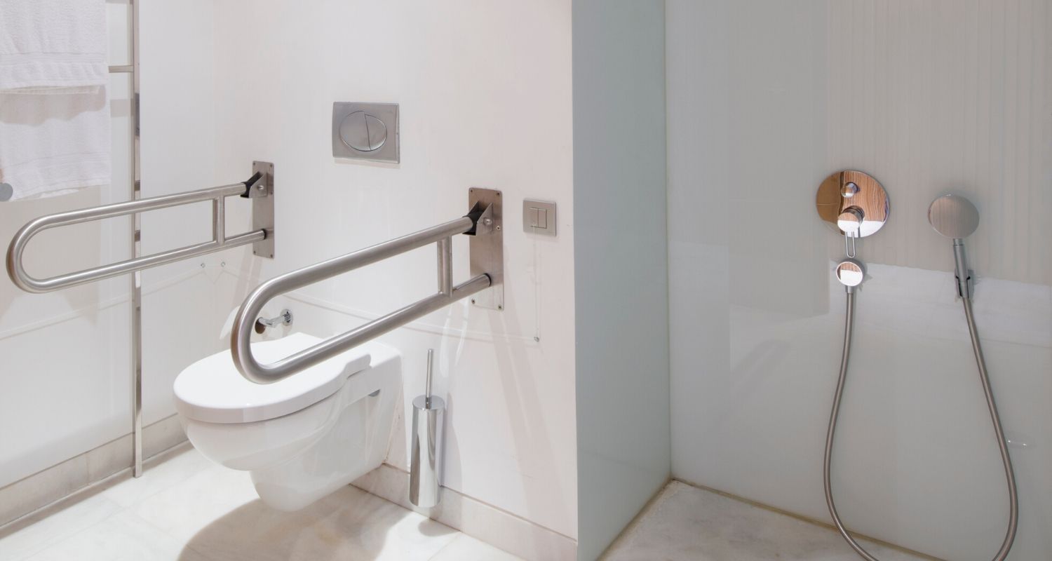 Adapted bathroom with grab rails and a wheel-in shower