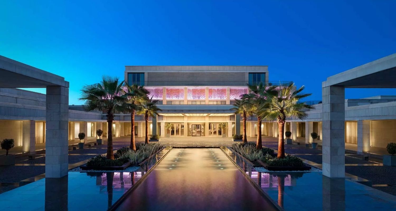 Hotel exterior at night with lights illuminating the space