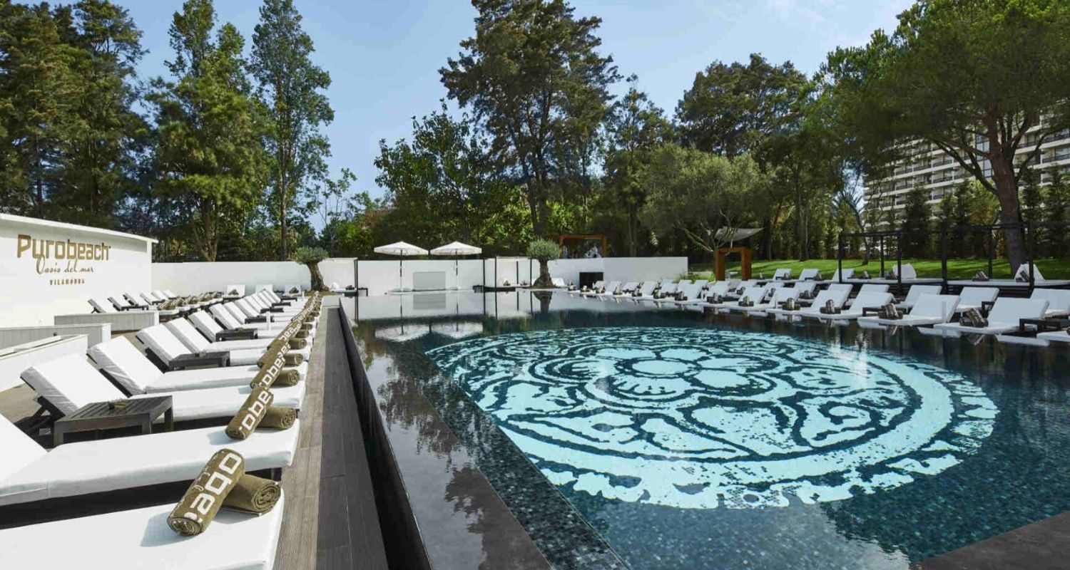 outdoor swimming pool surrounded by sunbeds