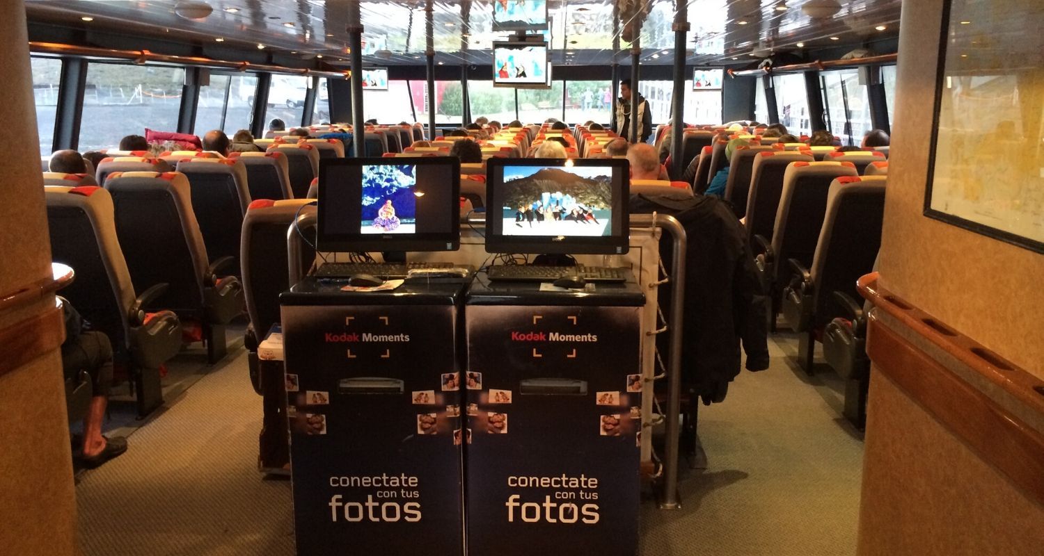 inside the ferry with comfy seating and small screens