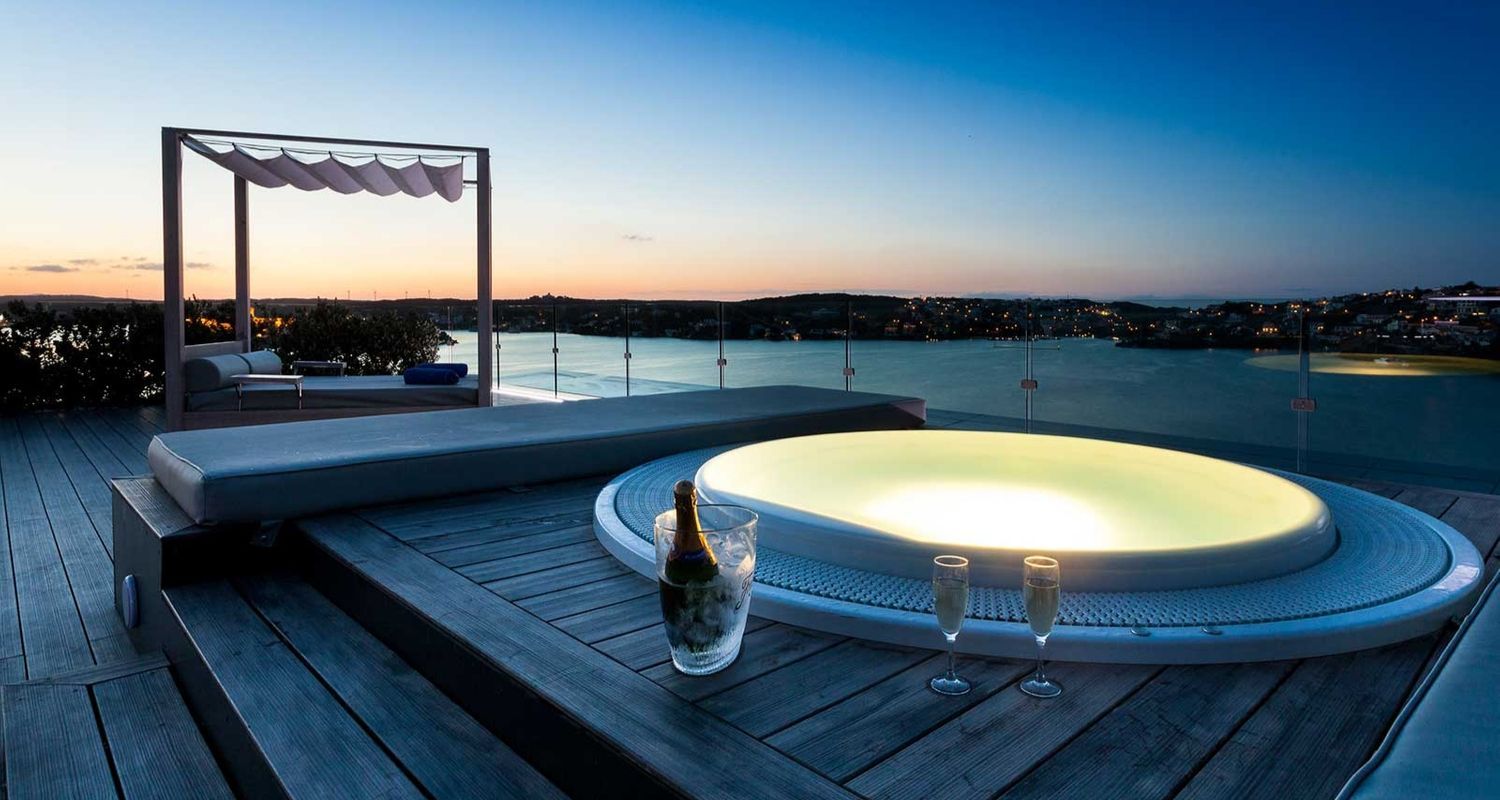 rooftop hot tub watching the sunset with a bottle of champagne