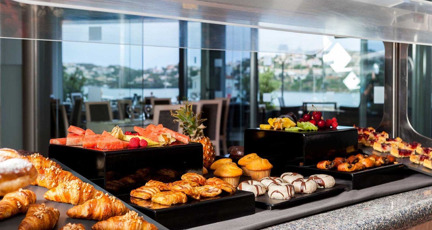 breakfast buffet with croissants, muffins and fresh fruit