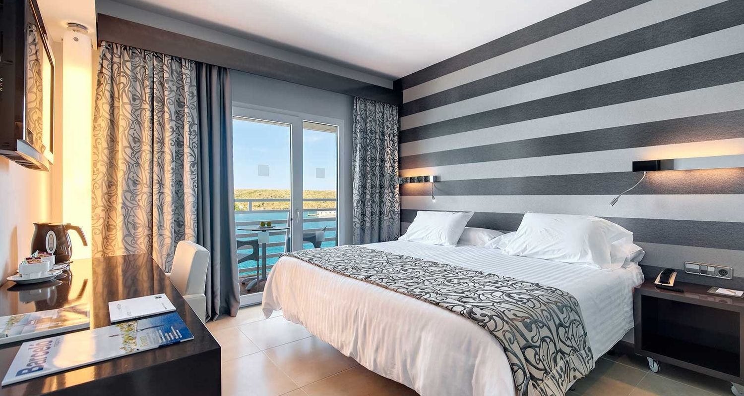 large hotel room with a sea view and balcony