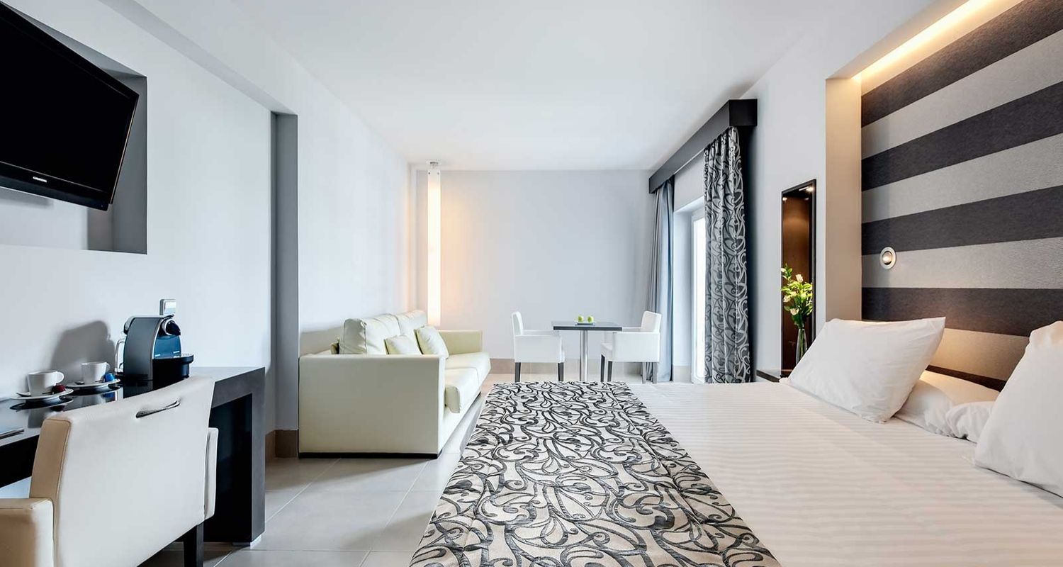 spacious hotel room with lounge area