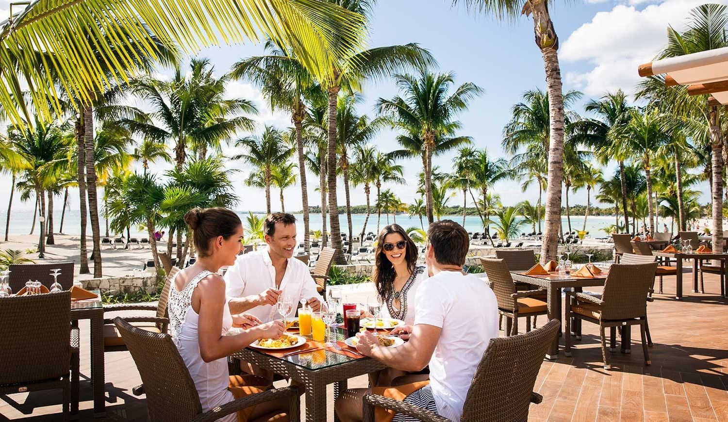 group enjoying a meal near the beach