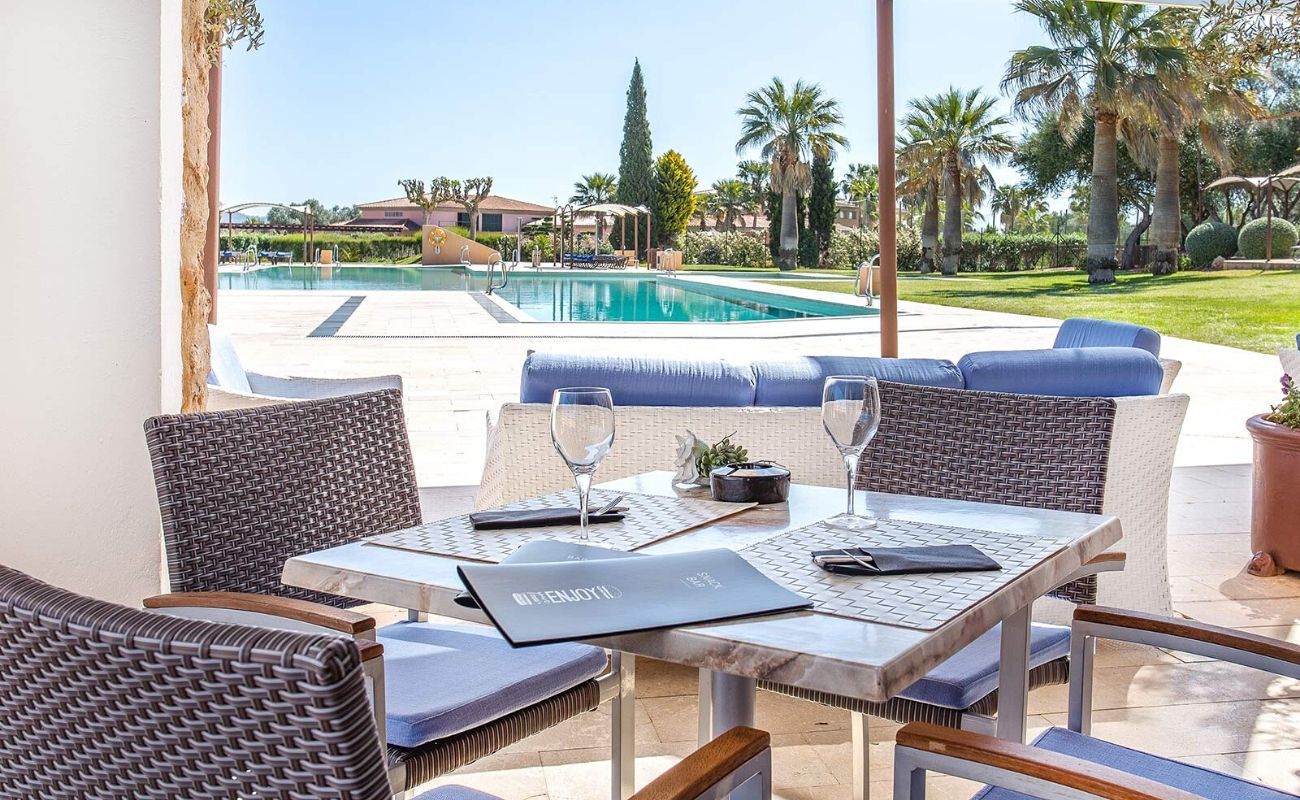 outdoor dining with a view of the pool