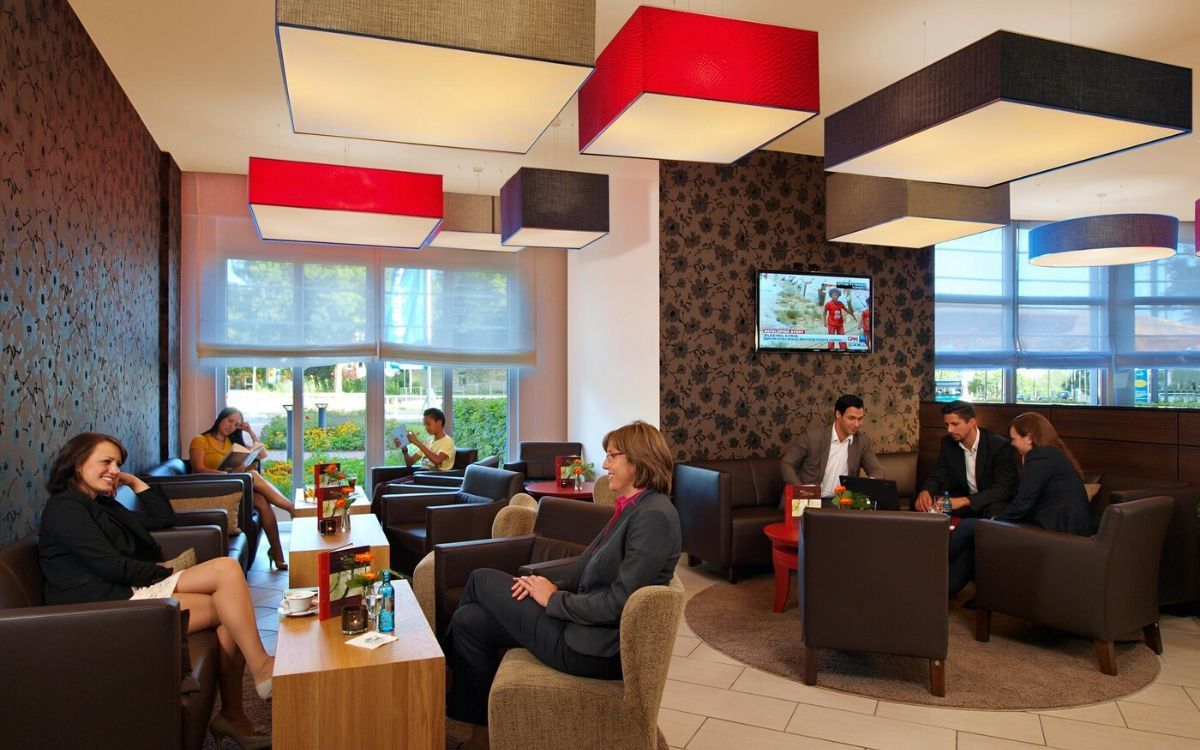 indoor lounge area with hotel guests relaxing