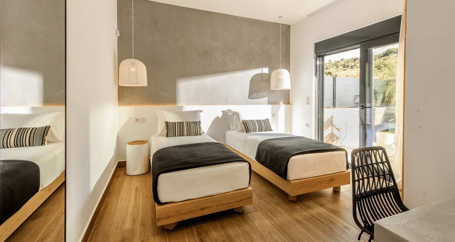 twin room with an outdoor patio