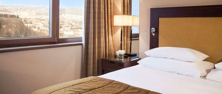 bright bedroom with a beautiful view of the city