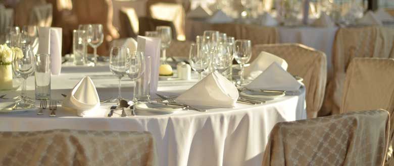 white place settings at venue tables