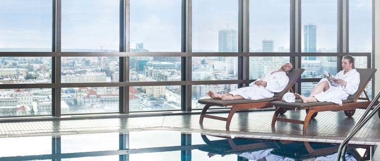 hotel guests enjoying the sunbeds near the indoor pool