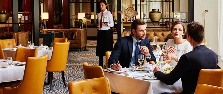 a couple and guest sitting in one of the hotels restaurants