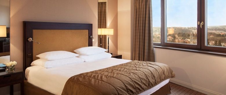 large bedroom with white and brown sheeting