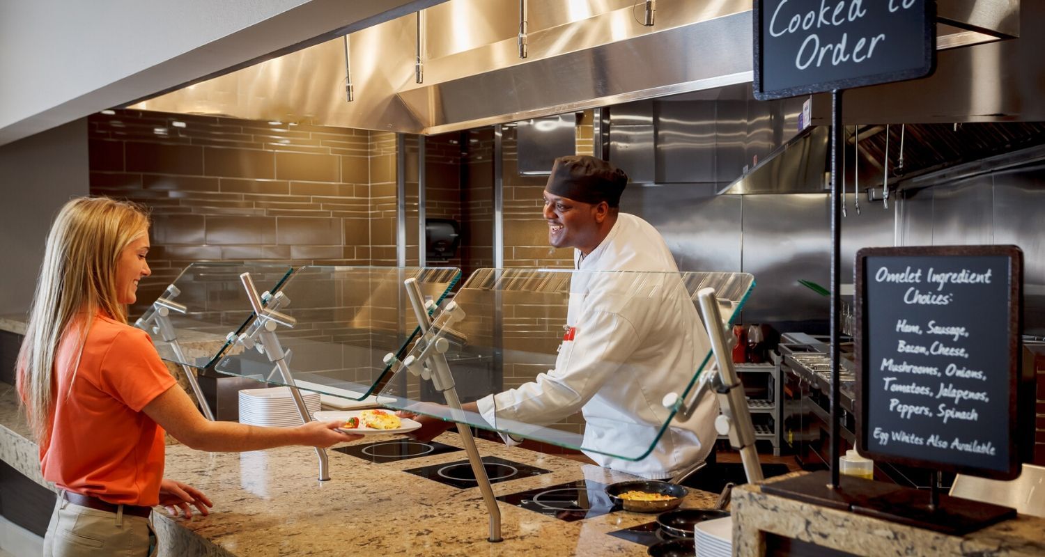 Friendly staff serving a hotel guest