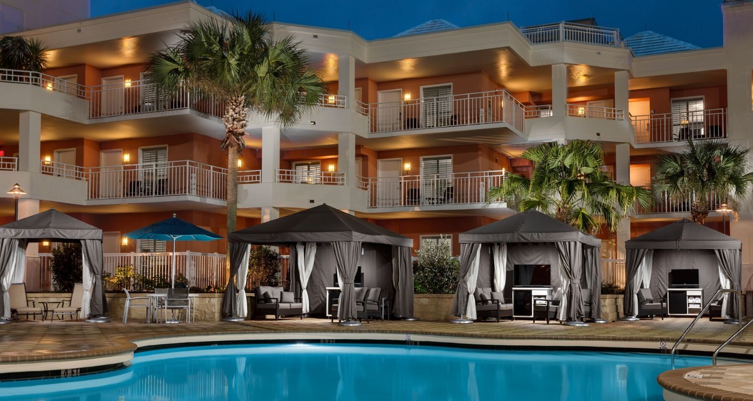 Apartment balconies overlooking the pool at night