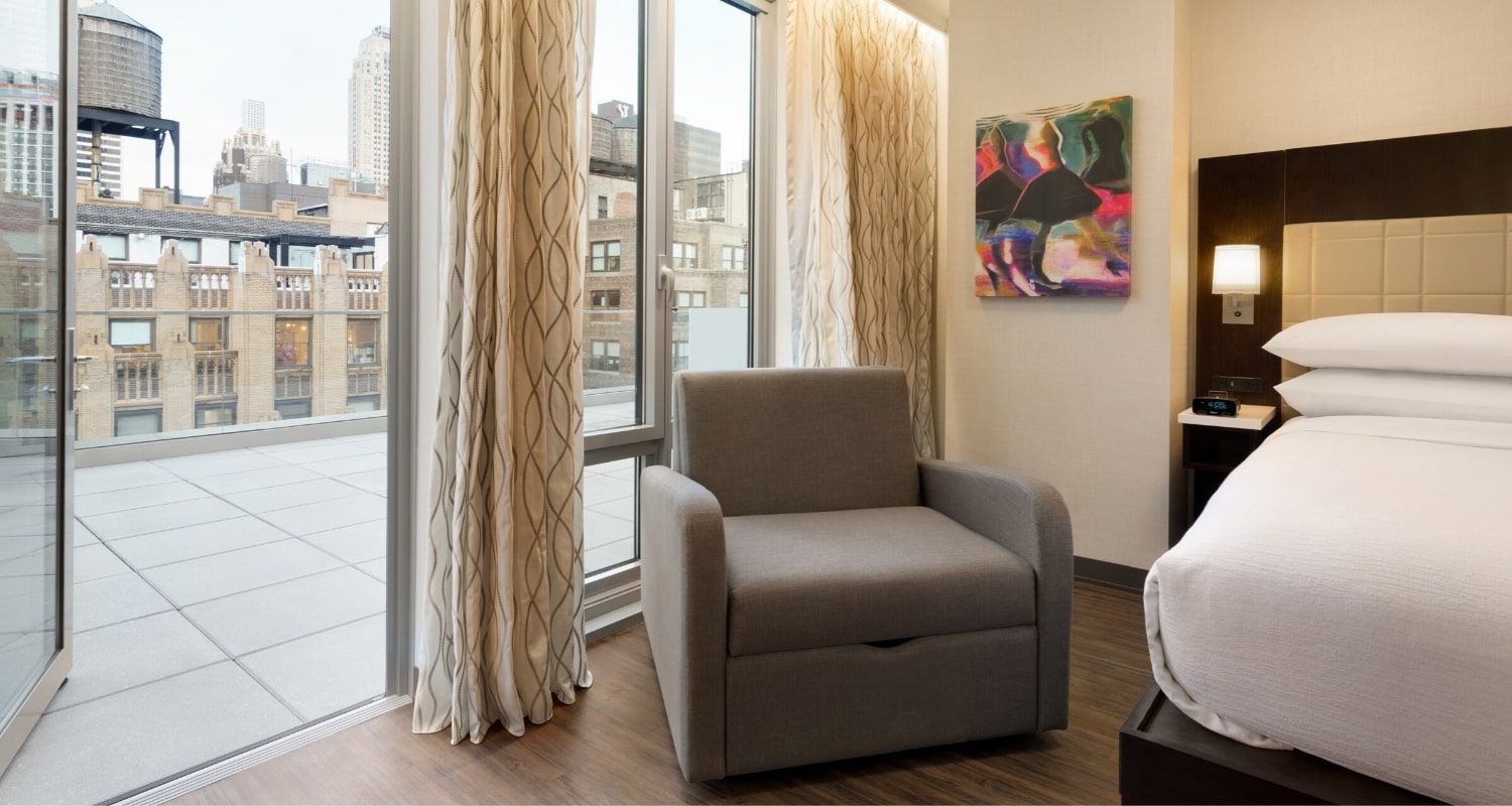 spacious bedroom with a balcony terrace