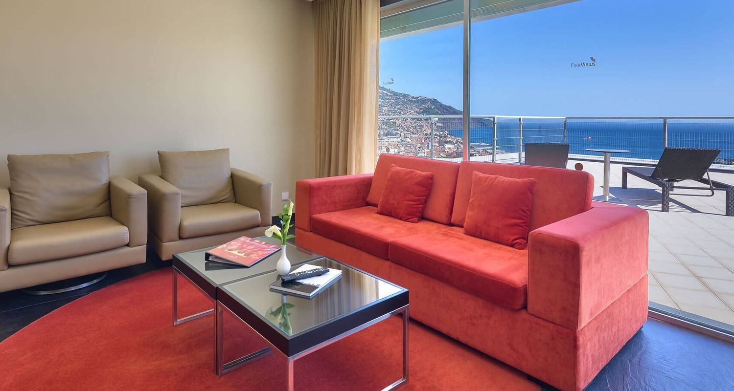 living room with a balcony terrace outside overlooking the ocean