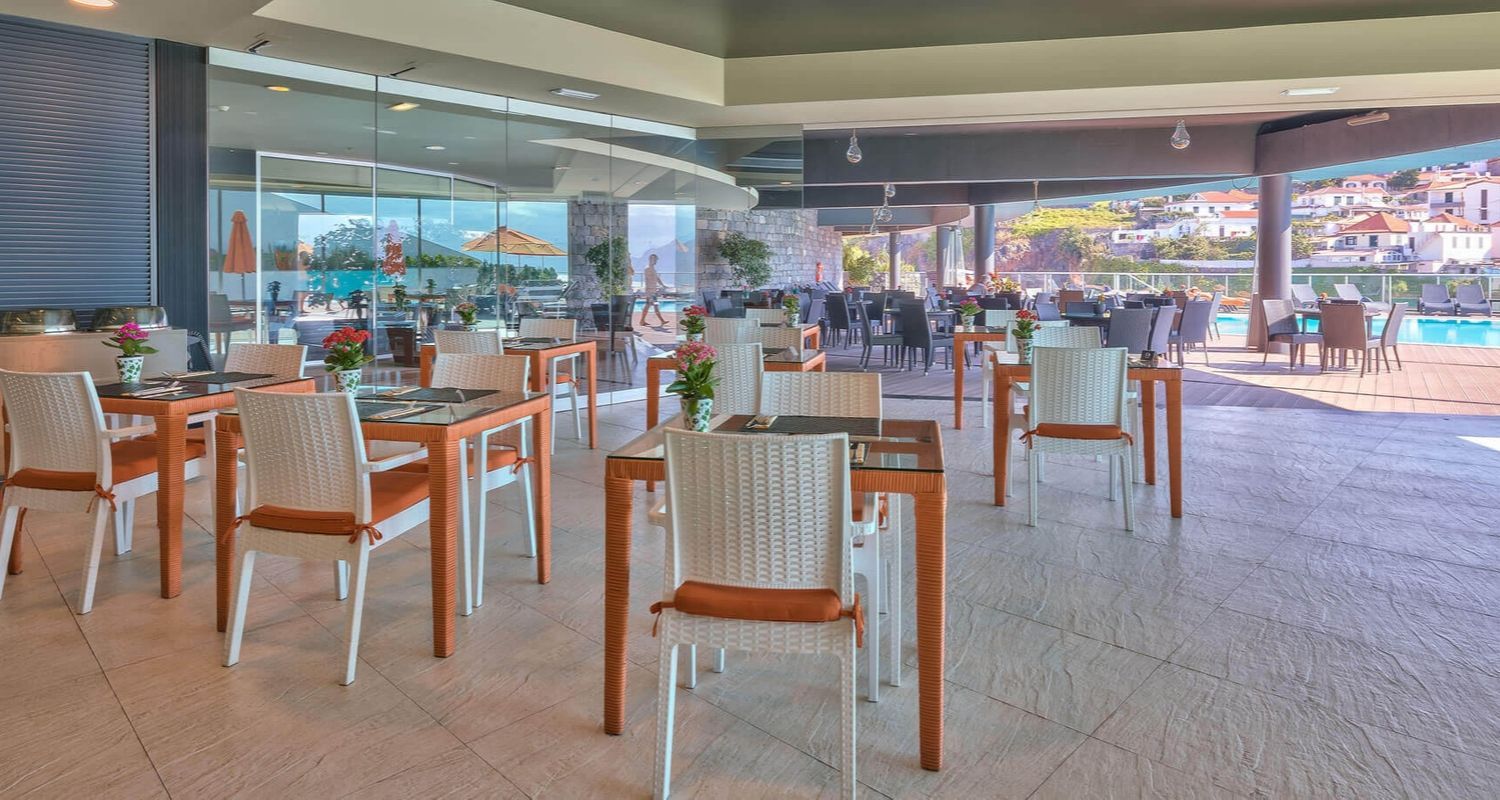indoor dining space near the outdoor swimming pool