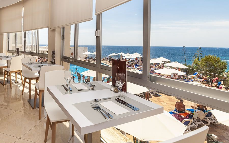 indoor dining area with a view of the pool and ocean