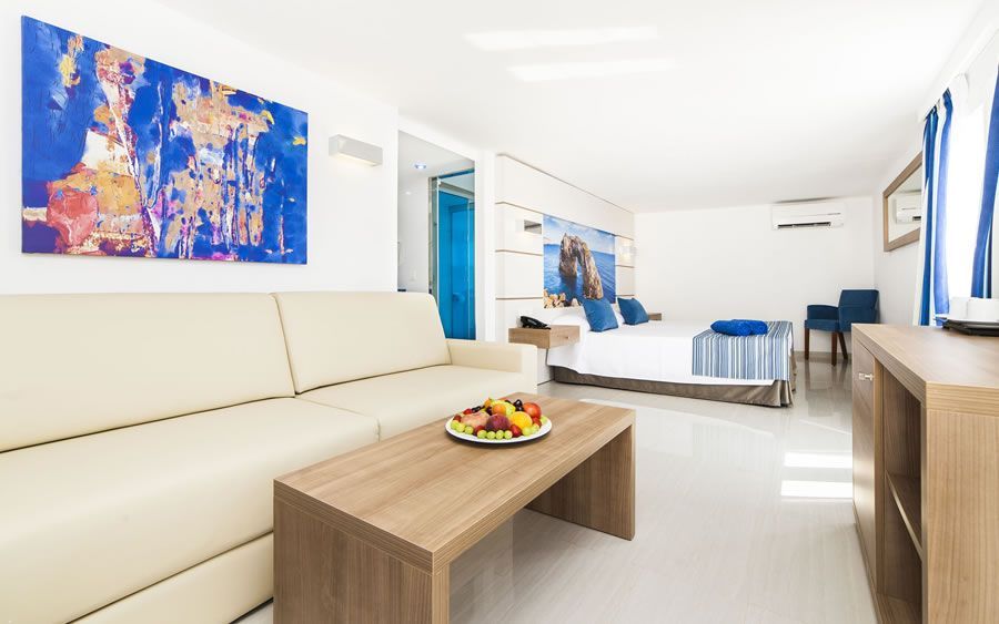 spacious hotel room with a sofa