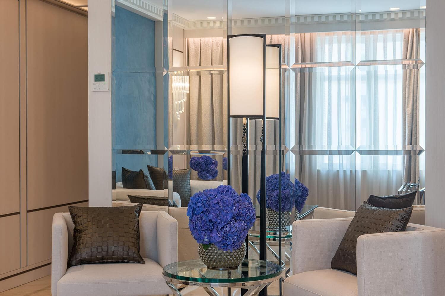 lounge area and large mirror in hotel suite