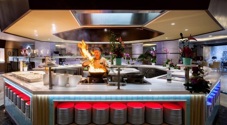 professional chef cooking over an open flame