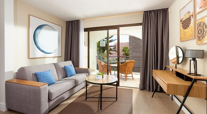 hotel room lounge area with a sofa and balcony terrace