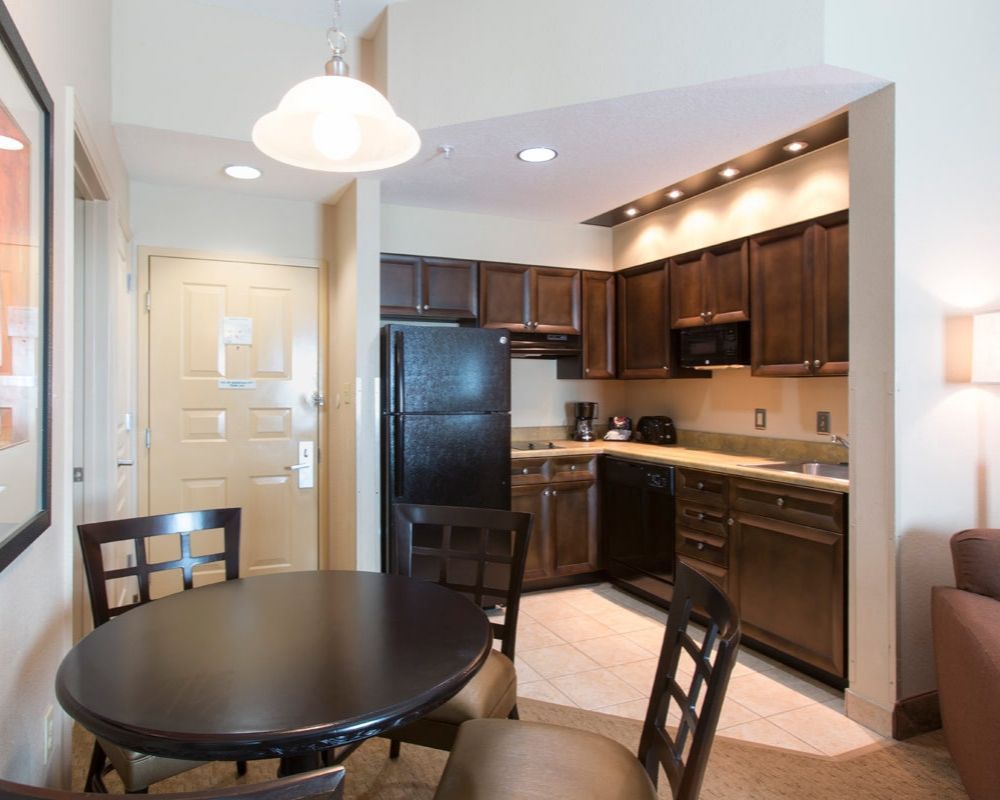 hotel room kitchen with food cooking and storing amenities