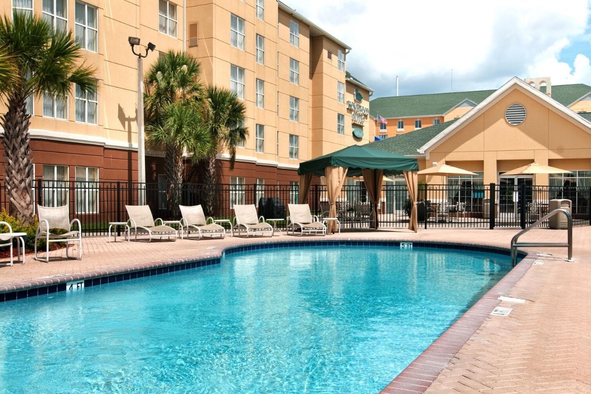Outdoor swimming pool surrounded by sunbeds