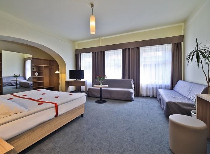 massive romantic suite with rose petals on the bed