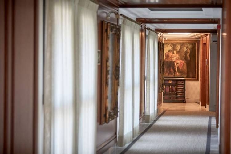 wide hallway leading to hotel rooms
