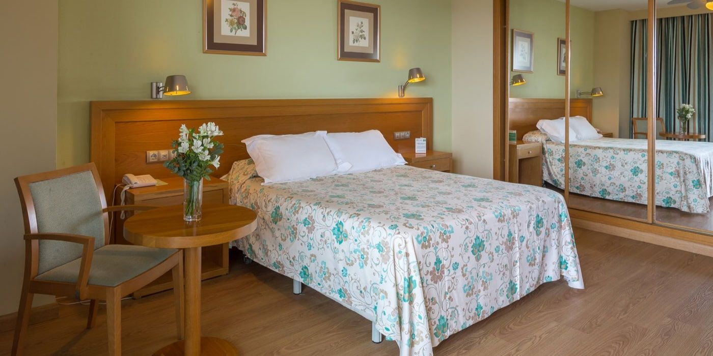 large bedroom with a mirror wardrobe