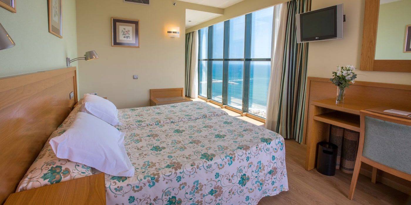 spacious bedroom with a sea view