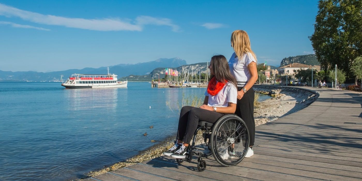 A couple of guests of Hotel Kriss looking across Lake Garda, one of which is in a wheelchair